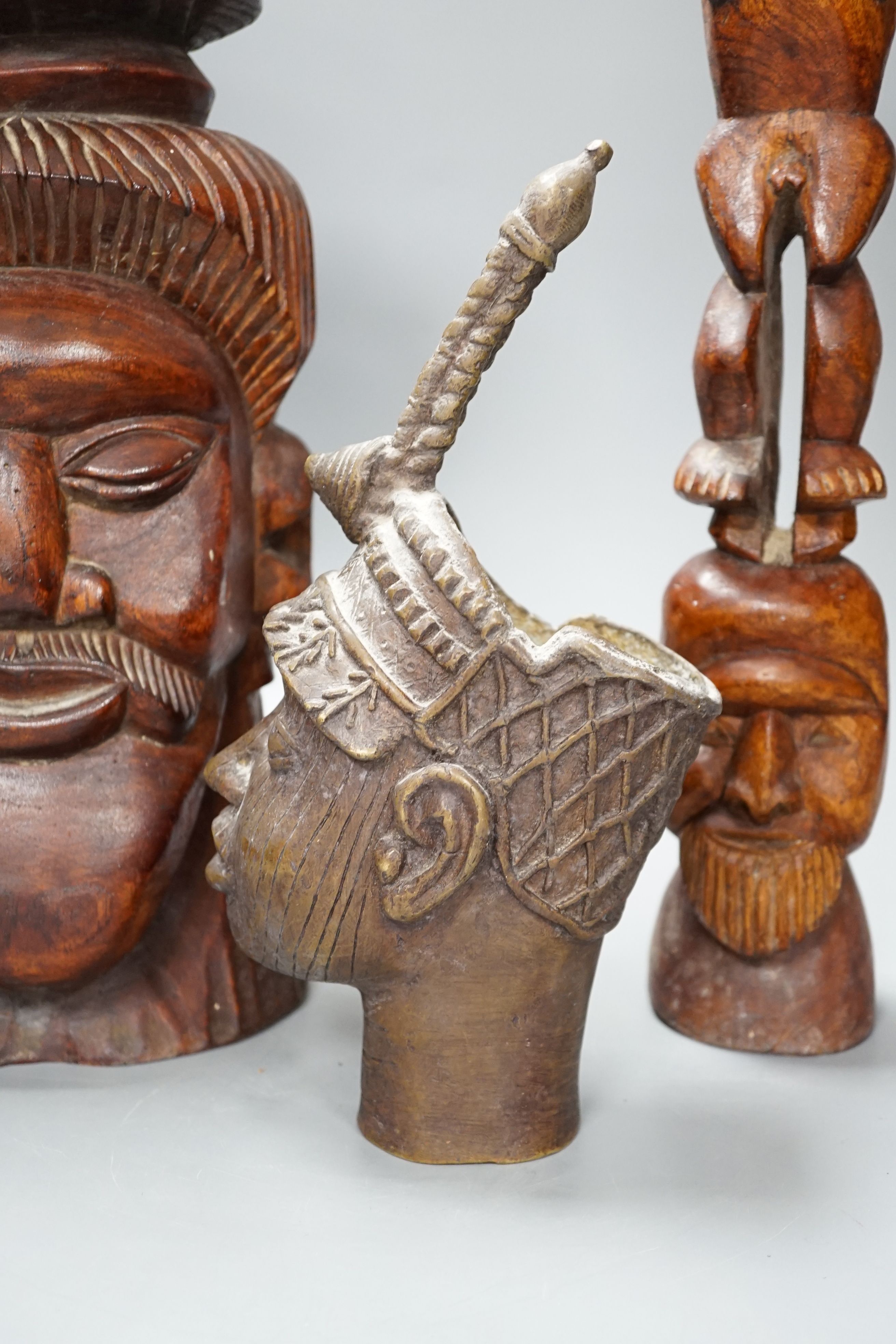 A metal Benin style bust, a carved tribal bust and another